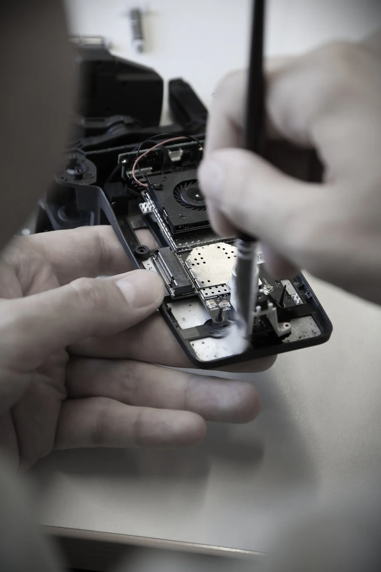 Technician repairing an unmanned system at a service bench